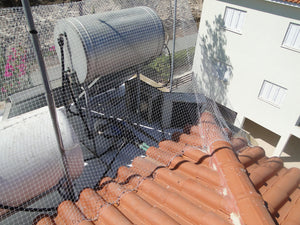 Stopping Pigeons, Sparrows or Starlings Accessing Flat Roof With Specialist Bird Netting Fixed Over Typical Cyprus Roof Hot Water Tank with One Or Two Solar Panels